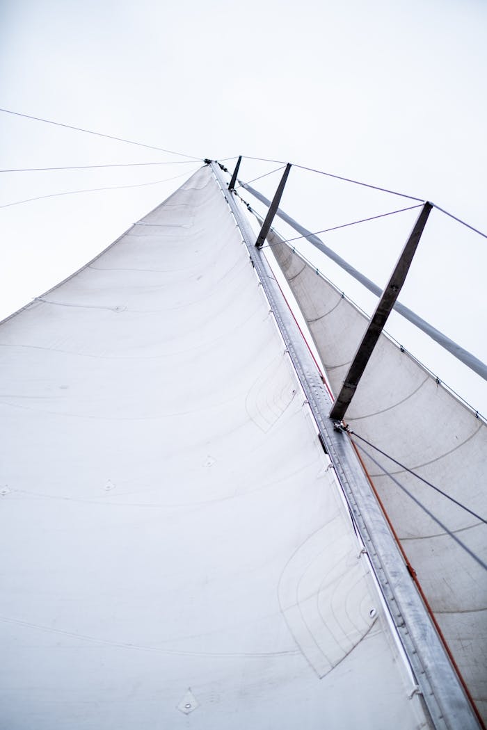 About Low angle view of a sailboat mast against a clear sky, showcasing maritime elegance.